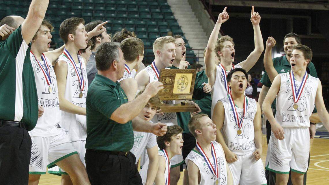 The Bishop Carroll boys basketball team celebrates its first state championship in school history. The Golden Eagles beat Salina Central 43-41 in overtime in the Class 5A final Saturday, March 10, 2018, at the Kansas Expocentre in Topeka.