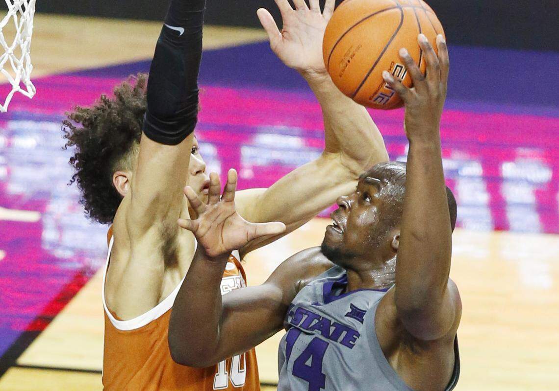 K-State forward Makol Mawien (14) goes up for a shot against Texas Wednesday night in Bramlage Coliseum. Mawien lead K-State’s scoring as the lost to Texas 67-47(January 2, 2019)
