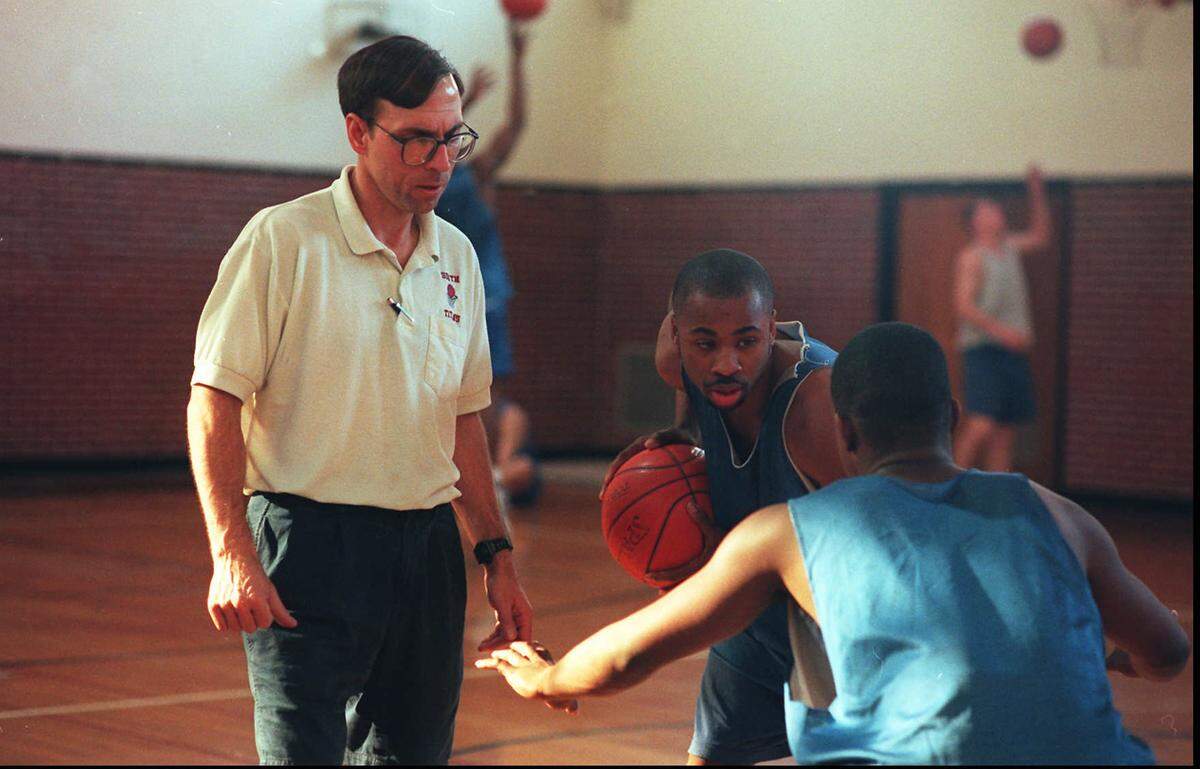 Steve Eck, who coached at South from 1986 to 1996, instructs point guard Jarred Weston during a practice.