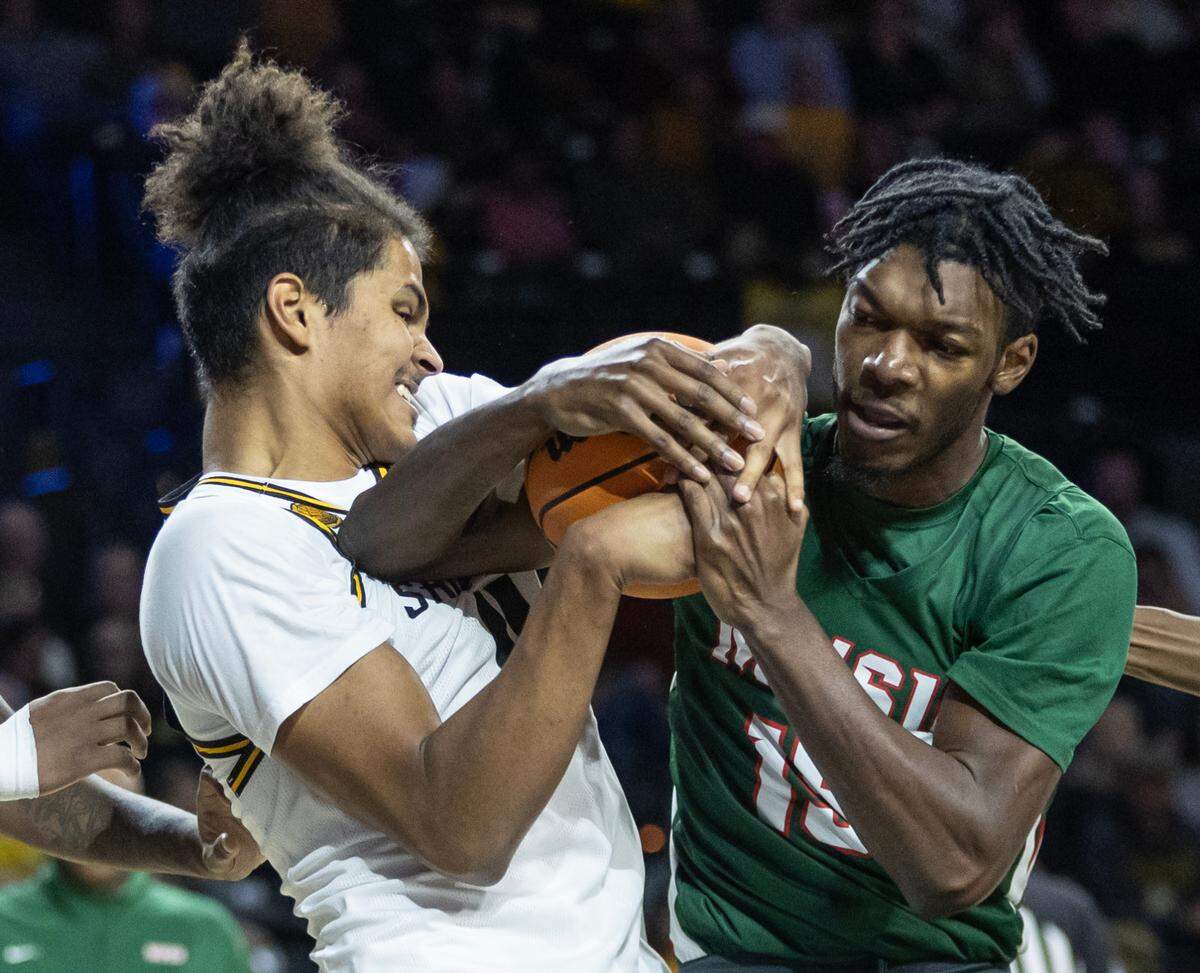 Wichita State’s Kenny Pohto fights for a rebound with Mississippi Valley’s Alvin Stredic during the first half of their game on Tuesday night at Koch Arena.