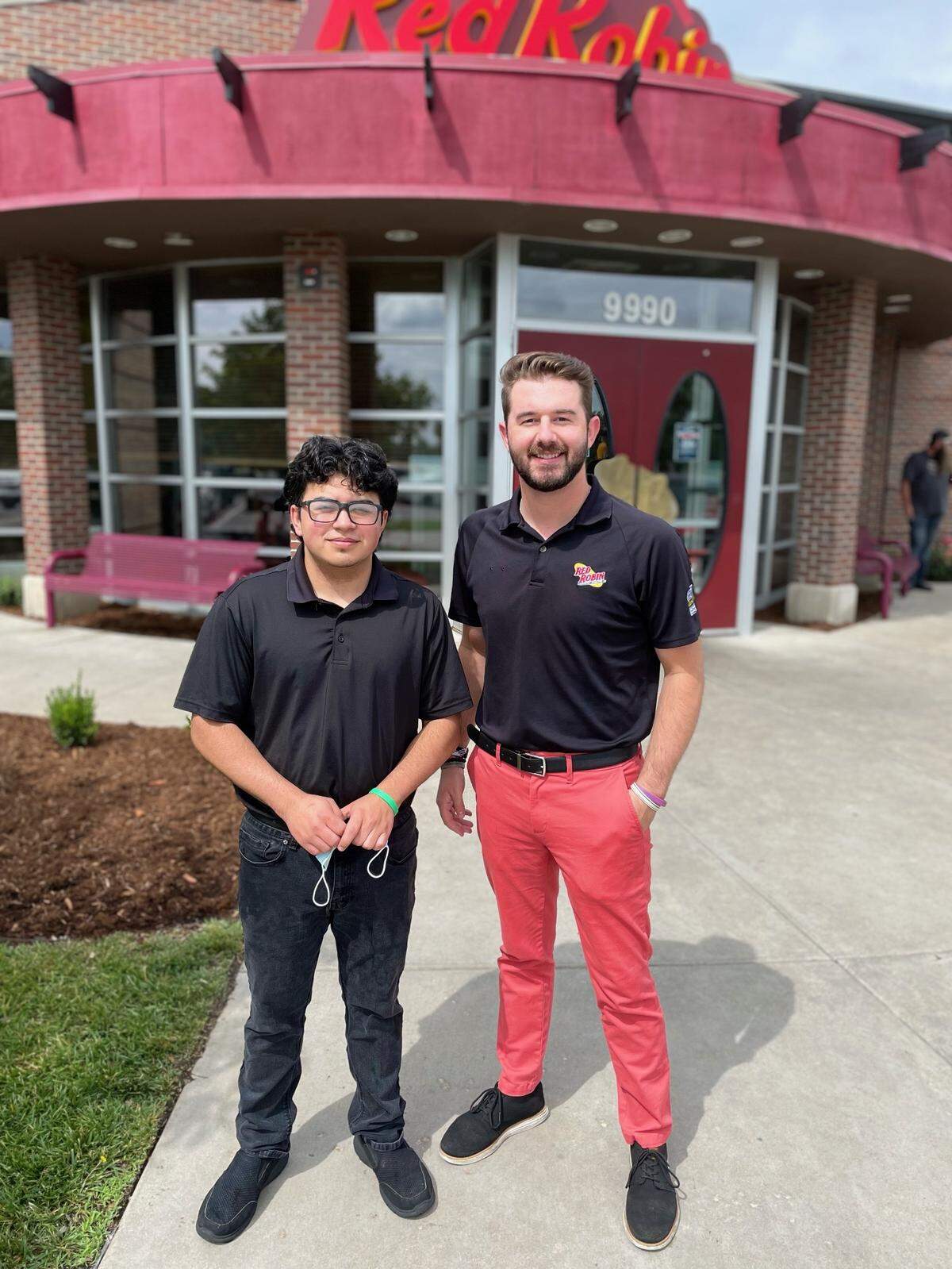 Red Robin busser Miguel Garcia, left, and assistant manager Breck Roop dug through five bags of trash to located a customer’s lost wedding ring.