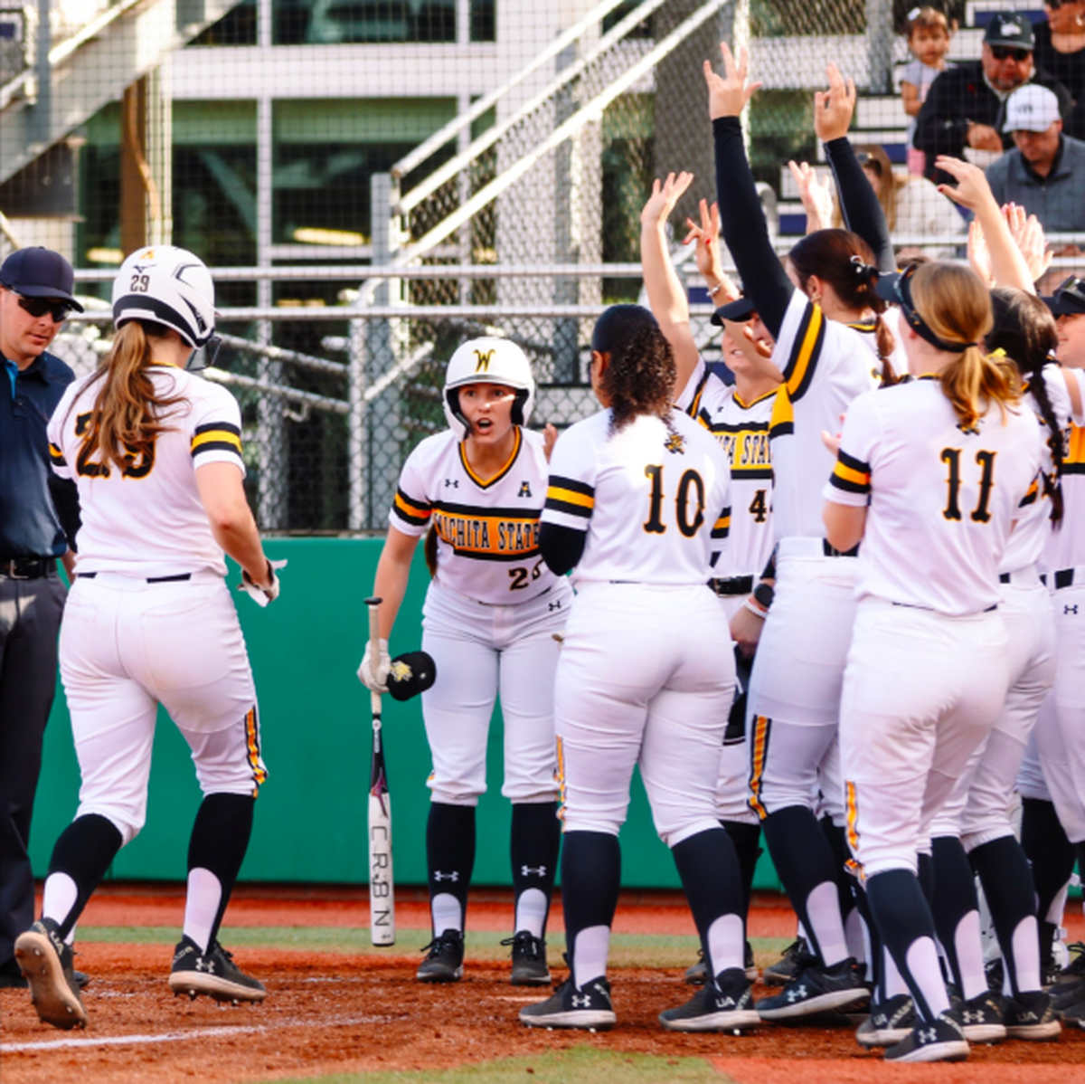 The Wichita State softball team celebrates following a home run in a season-opening tournament hosted by Grand Canyon this weekend.