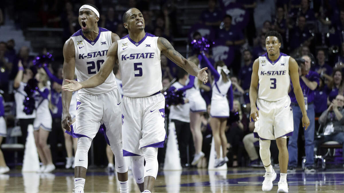 Kansas State guard Barry Brown (5) and forward Xavier Sneed (20) celebrate during the second half of an NCAA college basketball game against Texas in Manhattan, Kan., Wednesday, Feb. 21, 2018. Kansas State defeated Texas 58-48. (AP Photo/Orlin Wagner)