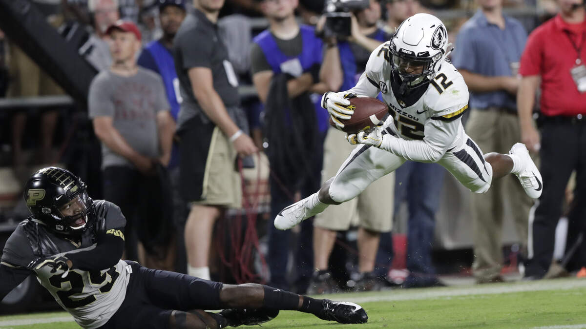 Missouri wide receiver Johnathon Johnson (12) makes a catch over Purdue cornerback Simeon Smiley (29) during the first half of an NCAA college football game in West Lafayette, Ind., Saturday, Sept. 15, 2018. (AP Photo/Michael Conroy)