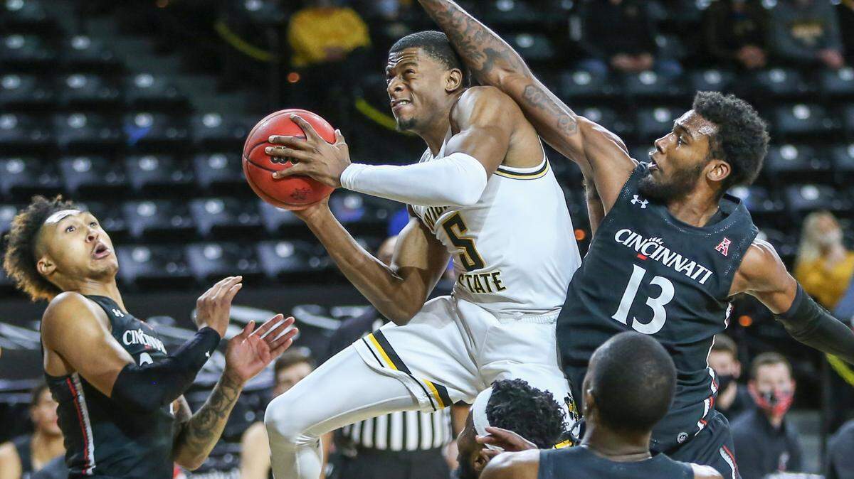 Wichita State’s Trey Wade goes to the basket against Cincinnati’s Tari Eason during first half on Sunday at Koch Arena.