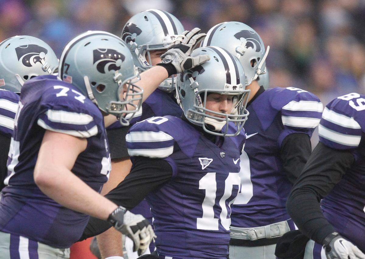 K-State teammates congratulate K-State Wildcats kicker Anthony Cantele (10) after his 3rd field goal Saturday. K-State defeated Iowa State 30-23.(Dec. 3, 2011)