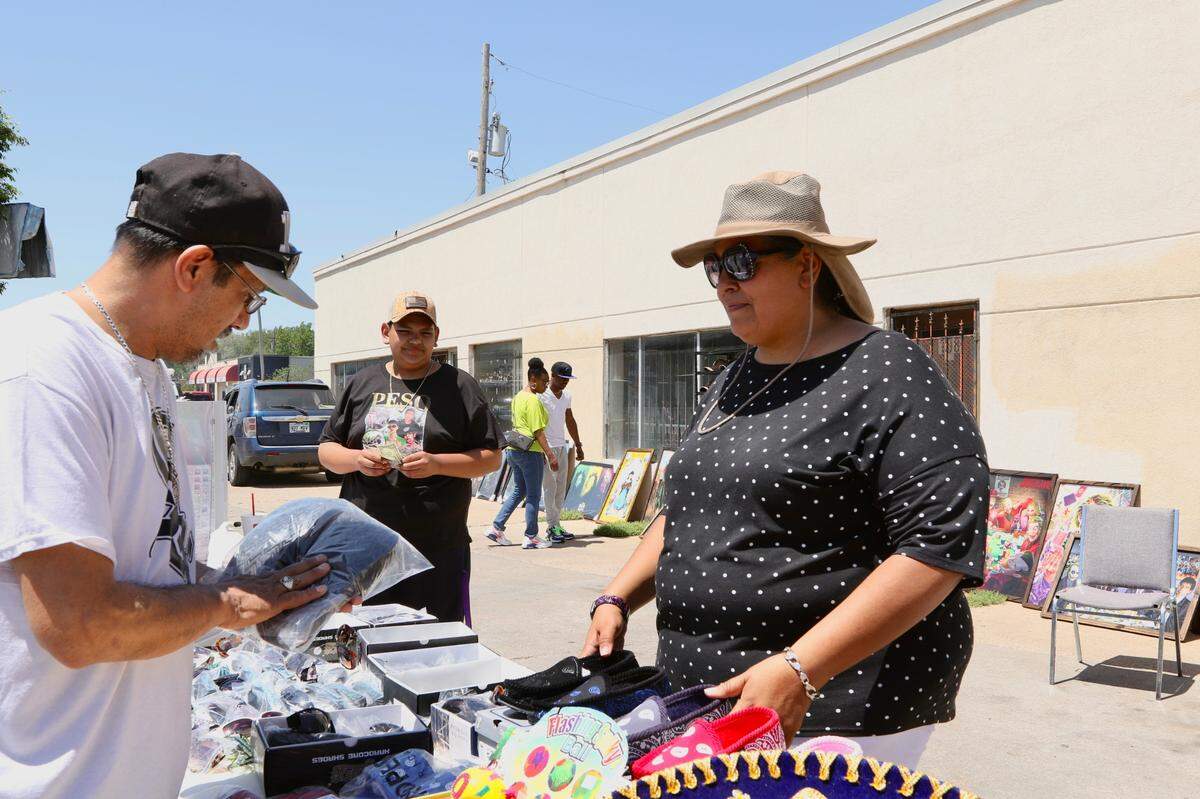 Erika Galindo (right) was one of the 140 vendors at Open Streets ICT Nomar on Sunday. Her longtime family business, Galindo’s Fashion, sells Hispanic inspired art, apparel, hats and accessories.