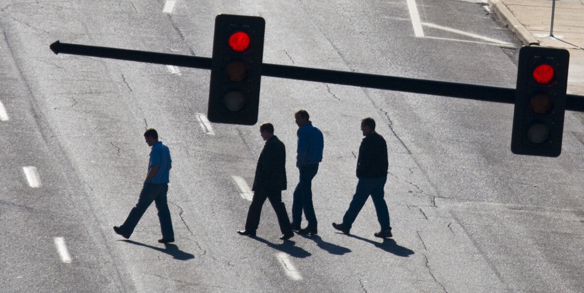 Pedestrians jaywalk across Topeka near Waterman.