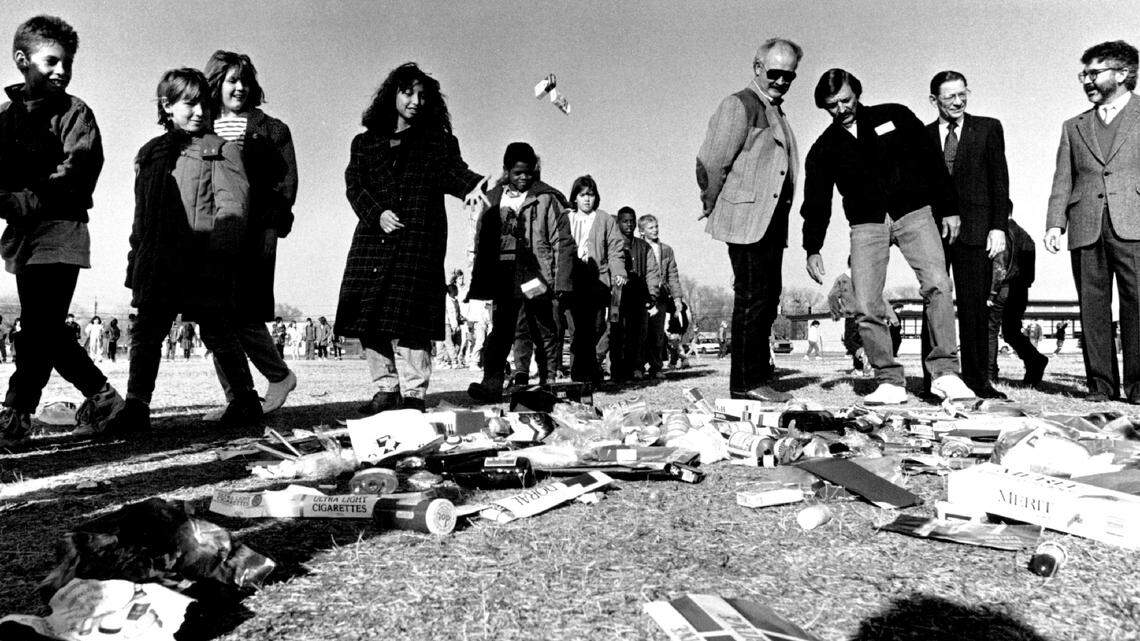 Students from Payne Elementary School toss empty cigarette cartons and liquor bottles into a pile as they participate in a drug awareness rally in 1990.