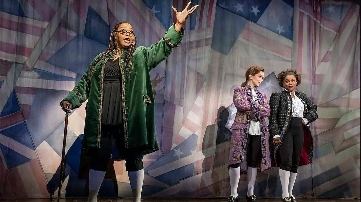 Liz Mikel plays Benjamin Franklin in “1776, The Musical,” with Nancy Anderson as Thomas Jefferson and Gisela Adisa as John Adams. The Kansas Republican Party held a drawing to win tickets to the play, in which the entire cast is female, transgender or nonbinary.