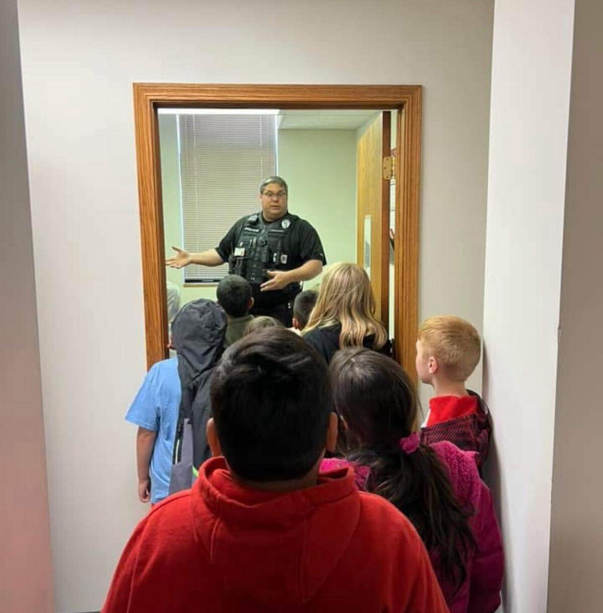 Student Resource Officer Paul Millard gives Park Elementary students a tour of the Great Bend Police Department.