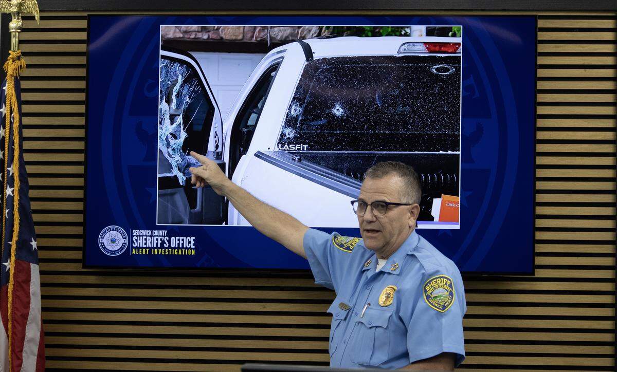 Sedgwick County Sheriff Jeff Easter points to where he said the bullet of a Wichita man’s self-inflicted gunshot wound struck the pickup window, as well as where the bullets of a responding WPD officer hit the vehicle.