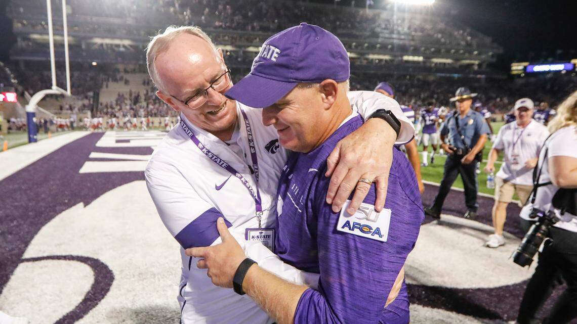 Athletic director Gene Taylor, left, hugs Chris Klieman after Klieman’s first win as the school’s new football coach at Bill Snyder Family Stadium in 2019.