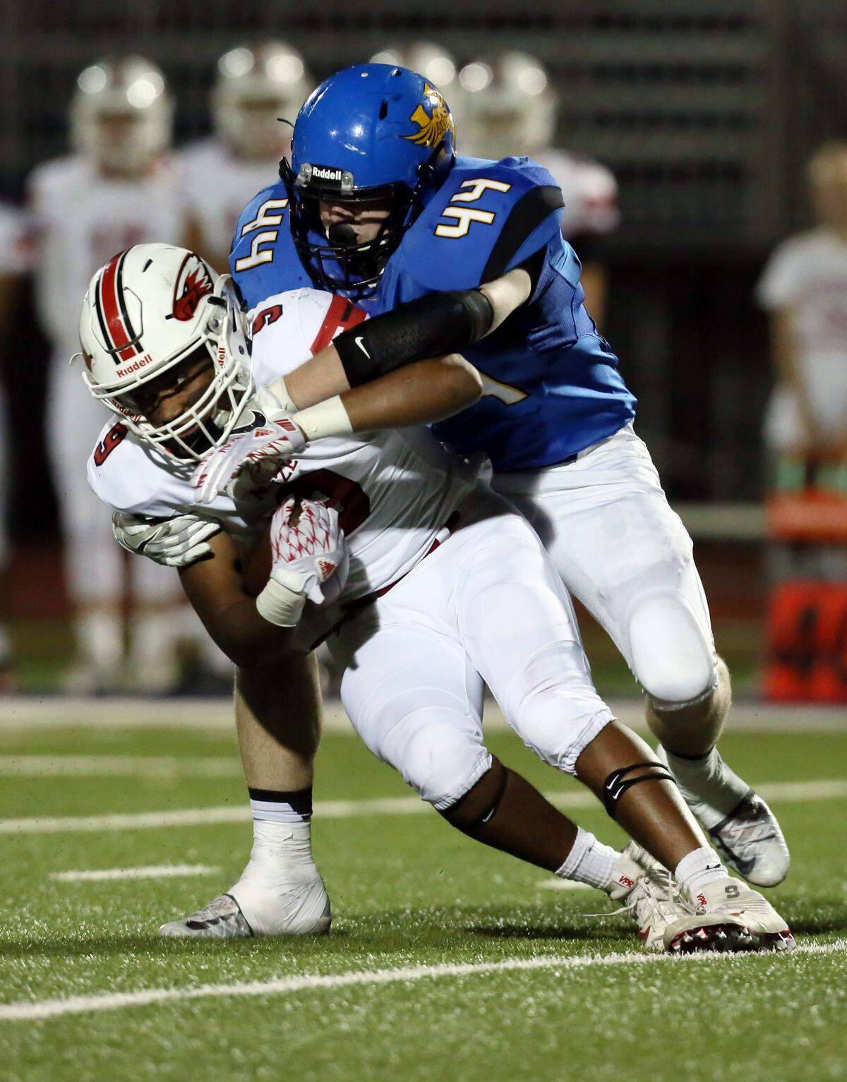 Hutchinson’s Braden Archer (44) brings down Maize’s Dalyn Johnson (9) during the first half of their game on Friday, Oct. 21, 2016, at Gowans Stadium in Hutchinson.