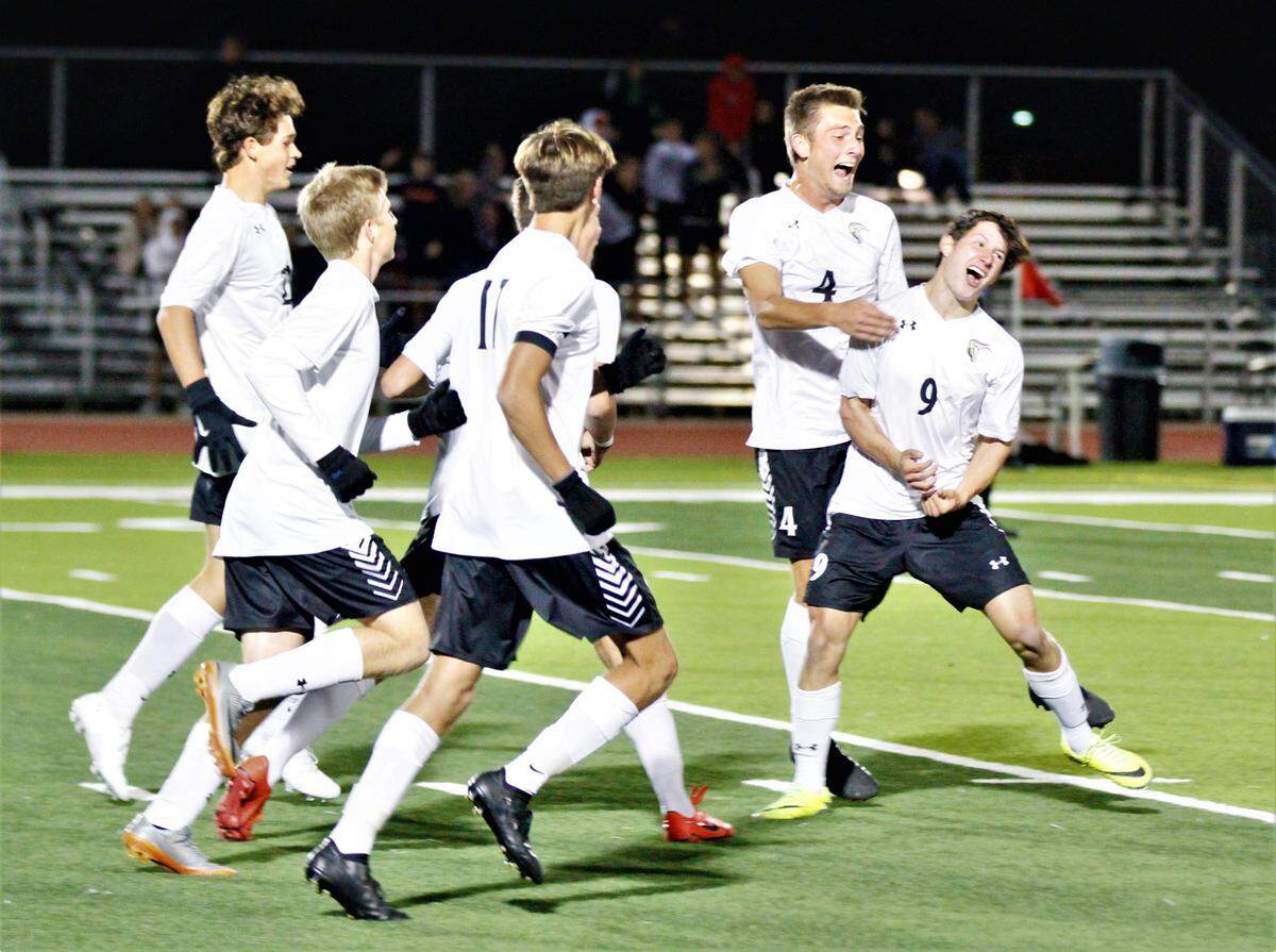 Maize South boys soccer celebrates a goal vs. Eisenhower