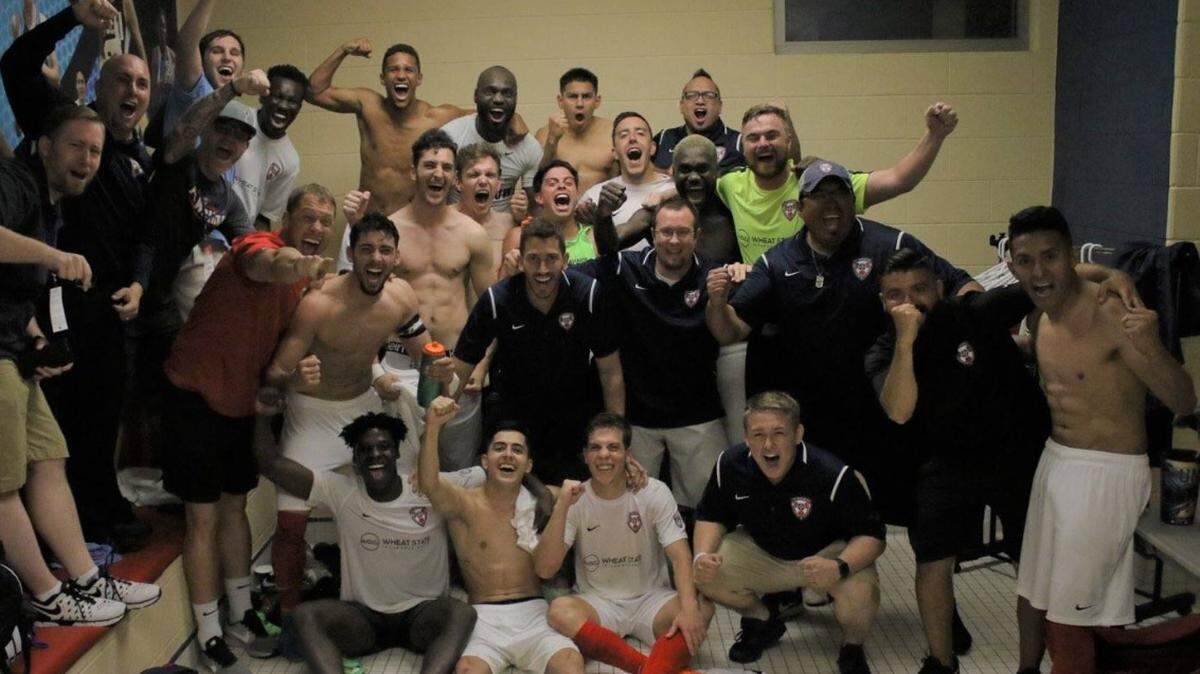 FC Wichita poses for a celebration picture in the locker room after defeating the Tulsa Roughnecks, 4-3, on Wednesday in the US Open Cup. It was the first time FC Wichita has beaten a professional team.