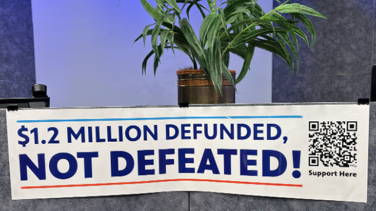 A sign on the set of a PBS Kansas 24-hour marathon pledge drive six weeks ago, after public broadcasting was defunded by Congress and President Trump.