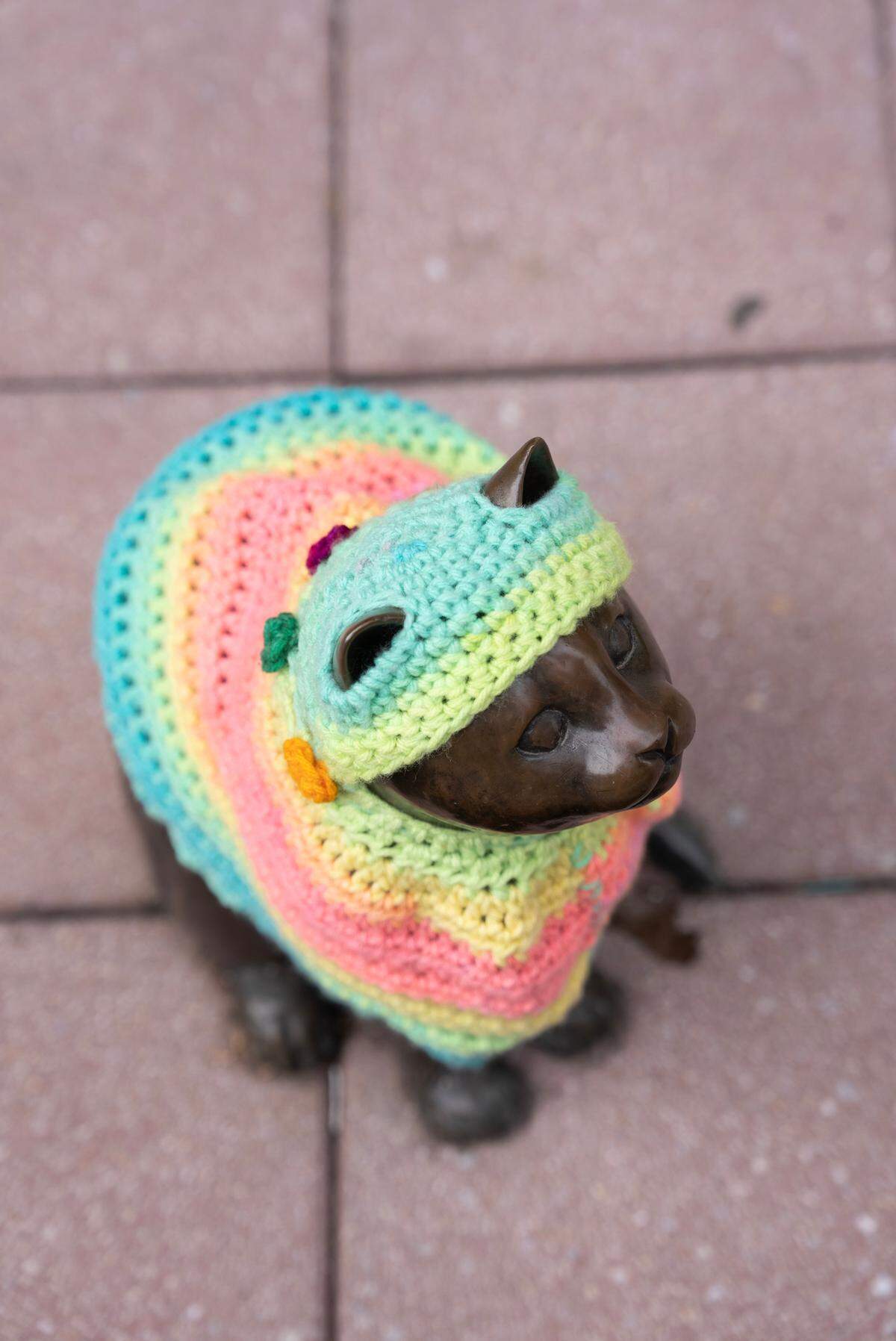 This kitty’s sweater was one of the first things swiped after crochet artist Tamara Gonzales dressed the statues downtown last weekend.