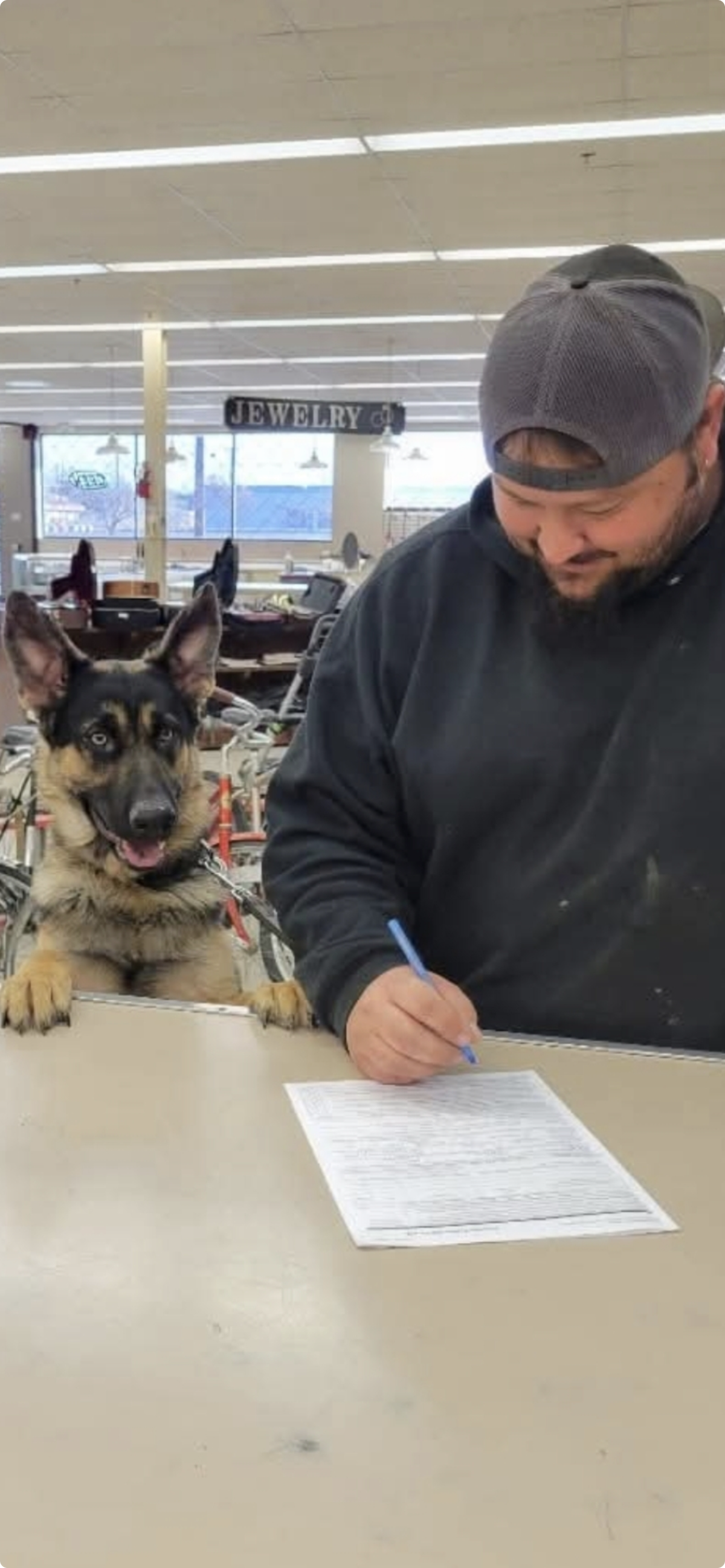 Two Money Town Pawn Shop customers at the counter of the store.