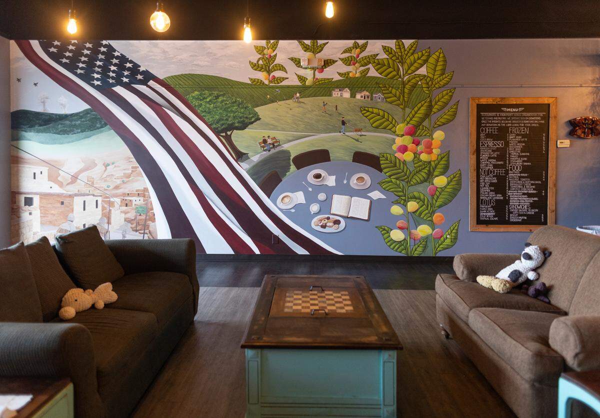 The mural on the wall at Sojourner’s Coffee House pays tribute to veterans.