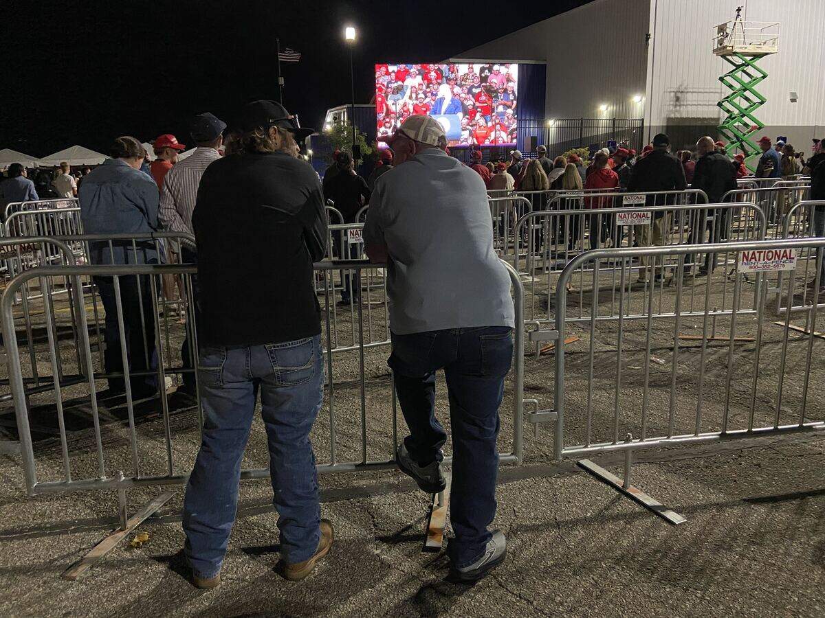 People watch the final portion of President Trump's speech in Kansas outside Heartland Credit Union Arena.