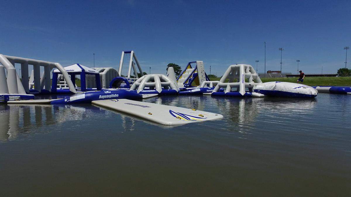 Splash Aqua Park ICT features inflatable obstacles on a sandpit lake.