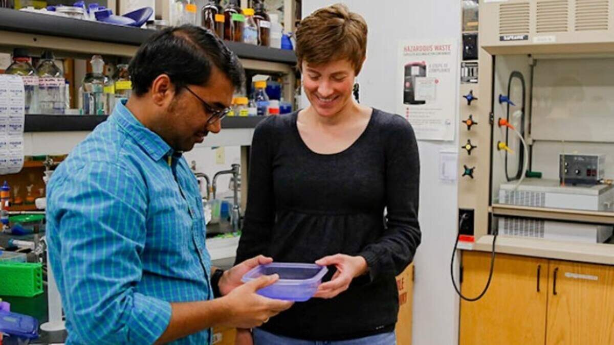 Cancer researcher Moriah Beck with a colleague in a lab at Wichita State University.