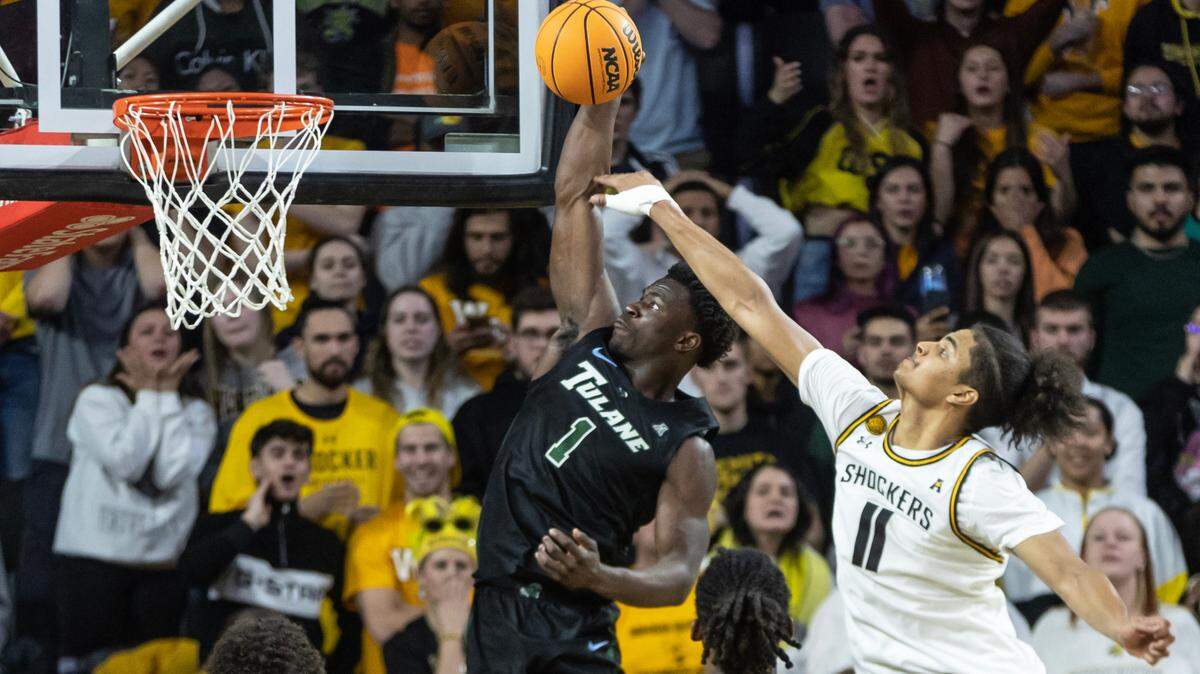 Tulane’s Sion James dunks the ball and is fouled by Wichita State’s Kenny Pohto late in the second half on Wednesday night. Though the Shockers would tie the game on the ensuing possession, Tulane went on to win the game in overtime, 95-90.