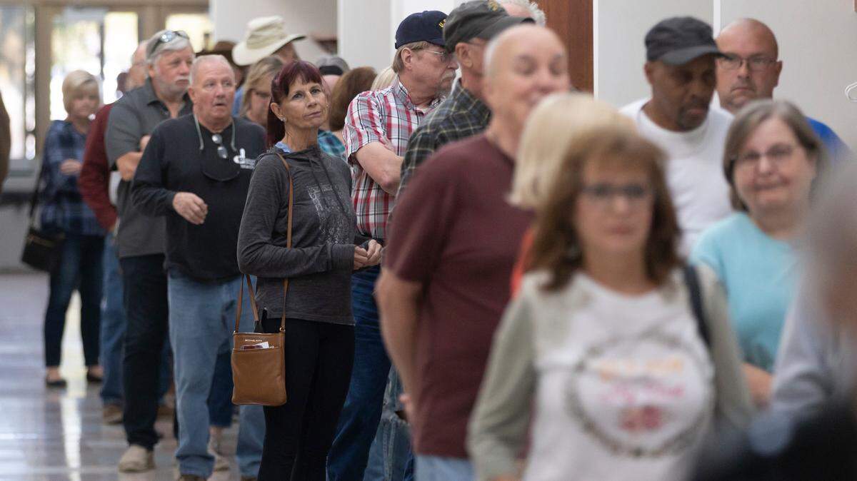 A line of voters about 50 people deep waits in a hallway at the Sedgwick County Extension Office on Tuesday.