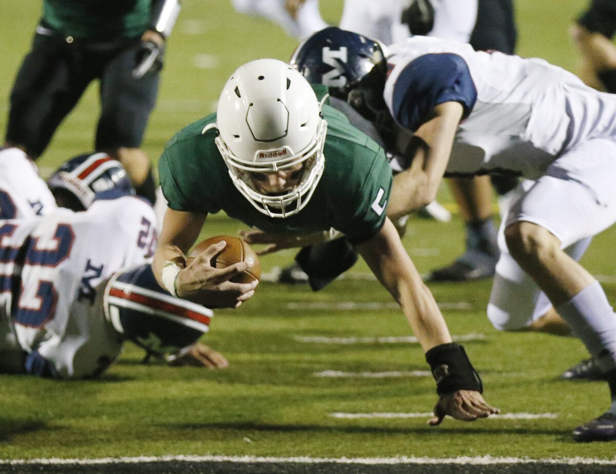 Derby quarterback Hunter Igo dives over the goal line in the 2nd quarter Friday as Derby took on Manhattan in Derby.  (November 16, 2018)