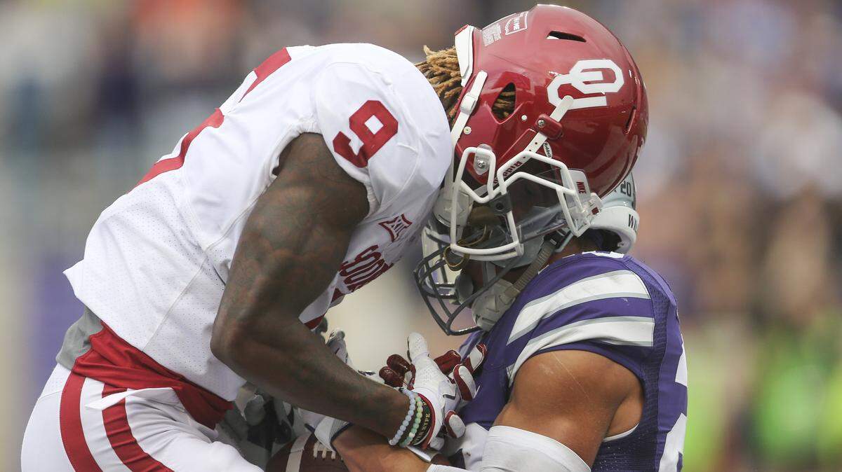 Kansas State defensive back Denzel Goolsby intercepts the ball from Oklahoma wide receiver CeeDee Lamb.