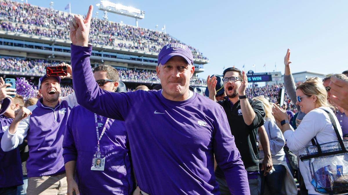 Kansas State head coach Chris Klieman celebrates with fans after his team took down No. 5 Oklahoma 48-41 at Bill Snyder Family Stadium on Oct. 26, 2019.