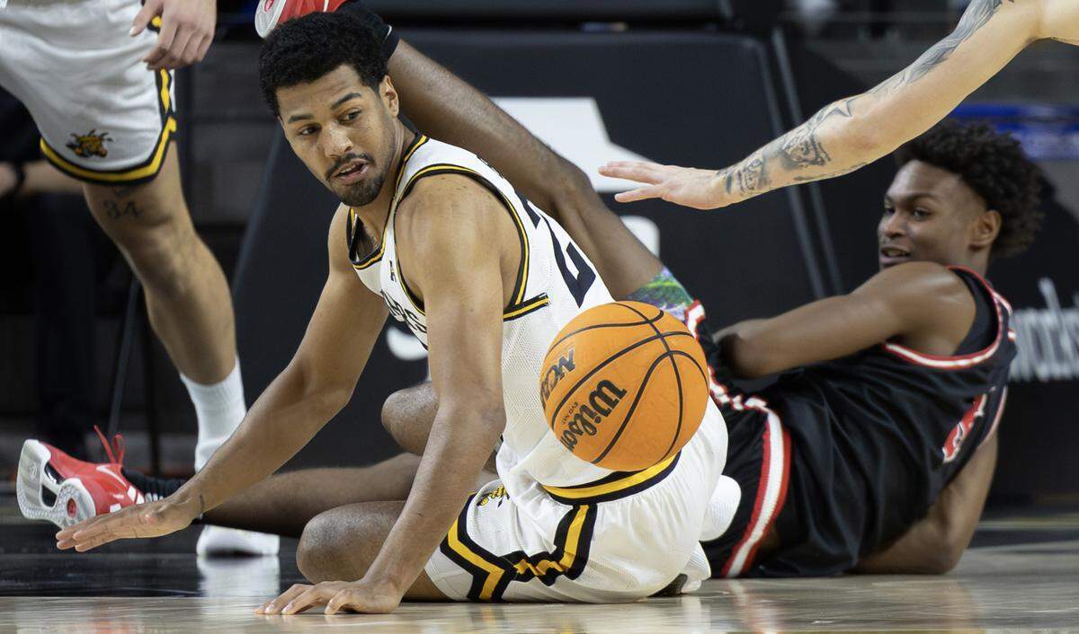 Wichita State’s Harlond Beverly turns for a loose ball during the first half of their came against Friends University on Sunday at Koch Arena.
