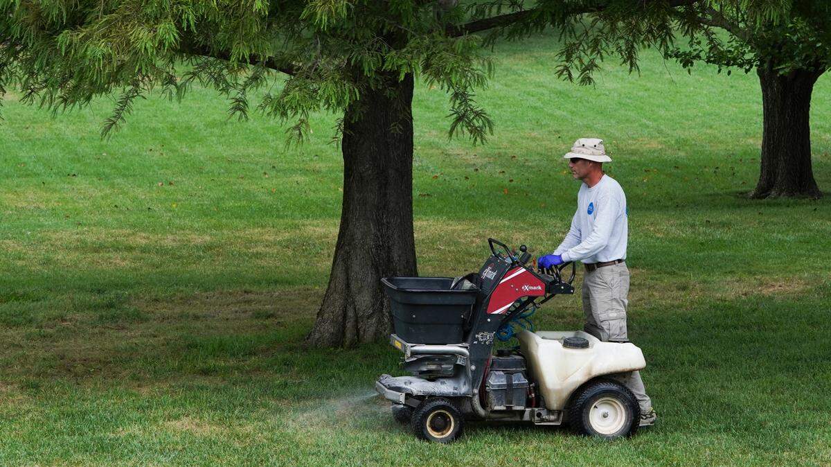 Duker Meyers, owner of Duke’s Lawn Care, sprays for armyworms on a west Wichita lawn. The invasive insect is killing lawns all over Wichita. Myers had 40 customers call on Saturday alone to have their lawns treated.​ (August 14, 2021)