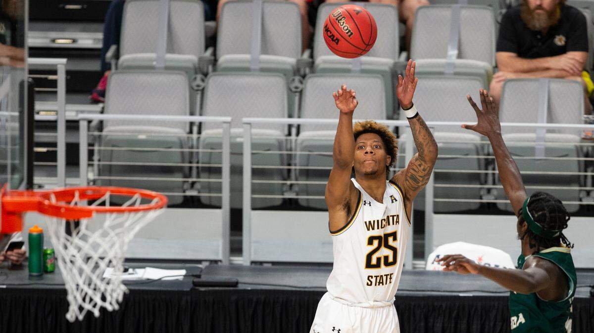 Wichita State’s Clarence Jackson hits a crucial three pointer against South Florida during the first half of their quarterfinal game of the American Athletic Conference Tournament on Friday in Ft. Worth.