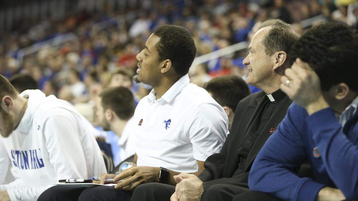 The Rev. John Dennehy travels with the Seton Hall basketball team and will be on the team bench again when the Pirates face the Kansas Jayhawks Saturday.