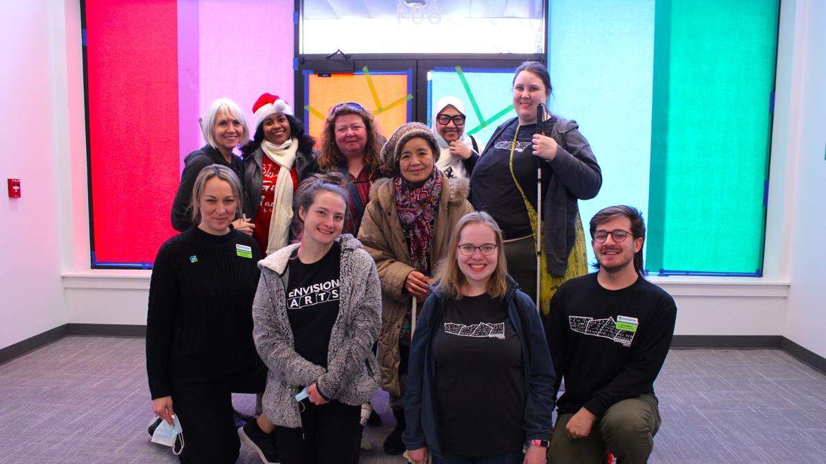 Sarah Kephart, Envision’s arts program manager, front row second from right, and Dale Small, Envision Arts Galley coordinator, front row far right, with Envision adult arts class students. The Envision Arts Gallery and Community Engagement Center opens this weekend.