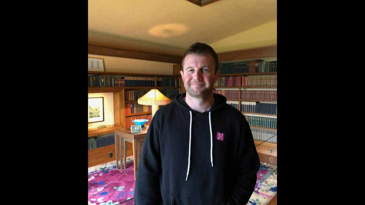 Thomas Doyle smiles as he poses for a photo in the Frank Lloyd Wright-designed Hollyhock House in Los Angeles.