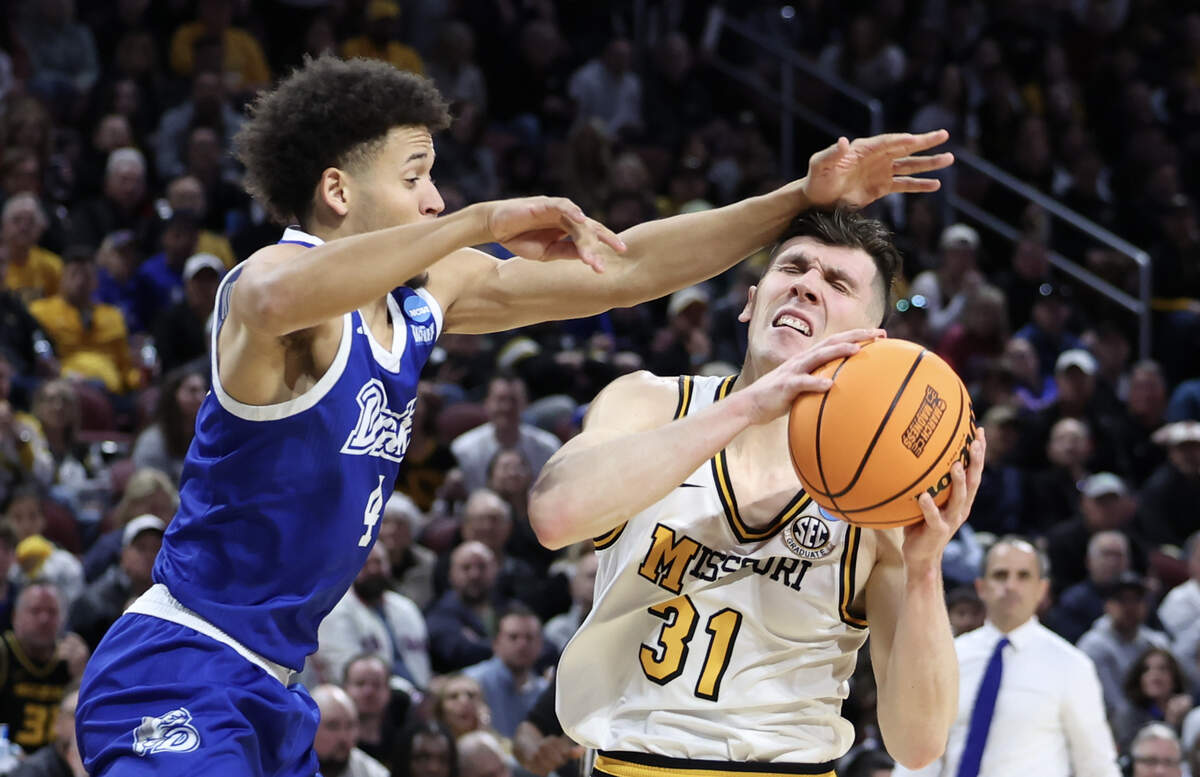Missouri guard Caleb Grill (31) is hit on the head by Drake guard Isaiah Jackson during the first half of their NCAA Tournament game in Wichita on Thursday, March 20, 2025.