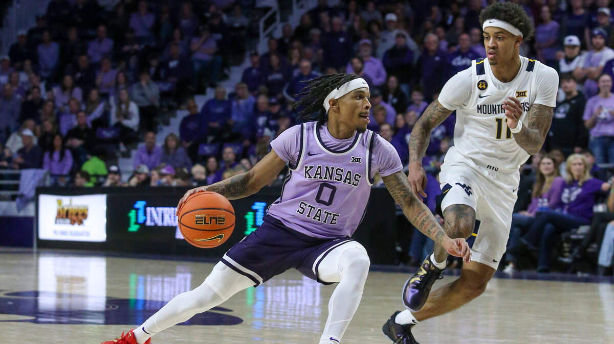 Kansas State Wildcats guard Dug McDaniel (0) dribbles the ball against West Virginia Mountaineers guard Jonathan Powell (11) during the first half at Bramlage Coliseum.