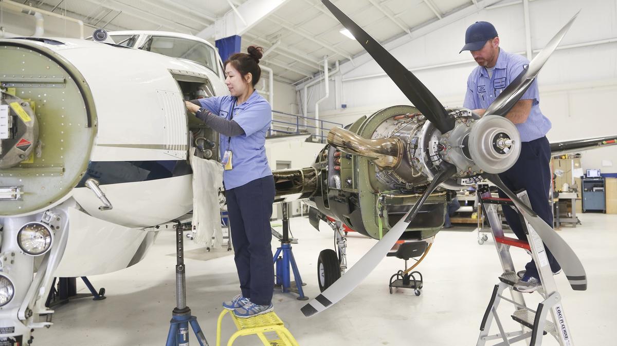 Lan Le, left, and Jordan Sasser work on a plane at Yingling Aviation in 2018. Yingling has added 50,000 square feet of hangar and office space at Wichita’s Dwight D. Eisenhower National Airport.