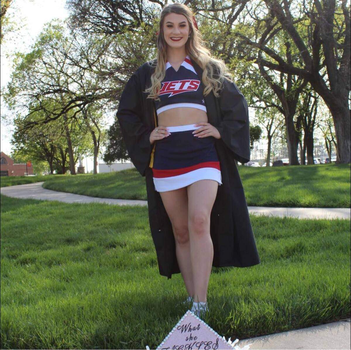 Brittnee Wicker poses for a graduation photo from Newman University in 2022. The 24-year-old, who was found fatally shot in her south Wichita apartment on Nov. 12, was a flyer on the cheerleading team.