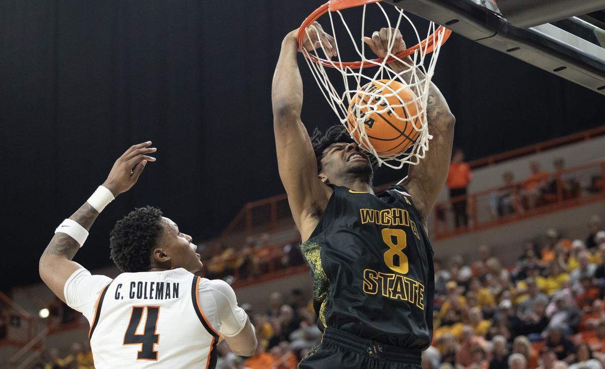 Wichita State’s Dillon Battie throws down a dunk against Oklahoma State’s Christian Coleman during the first half of their second round NIT game on Sunday in Stillwater.