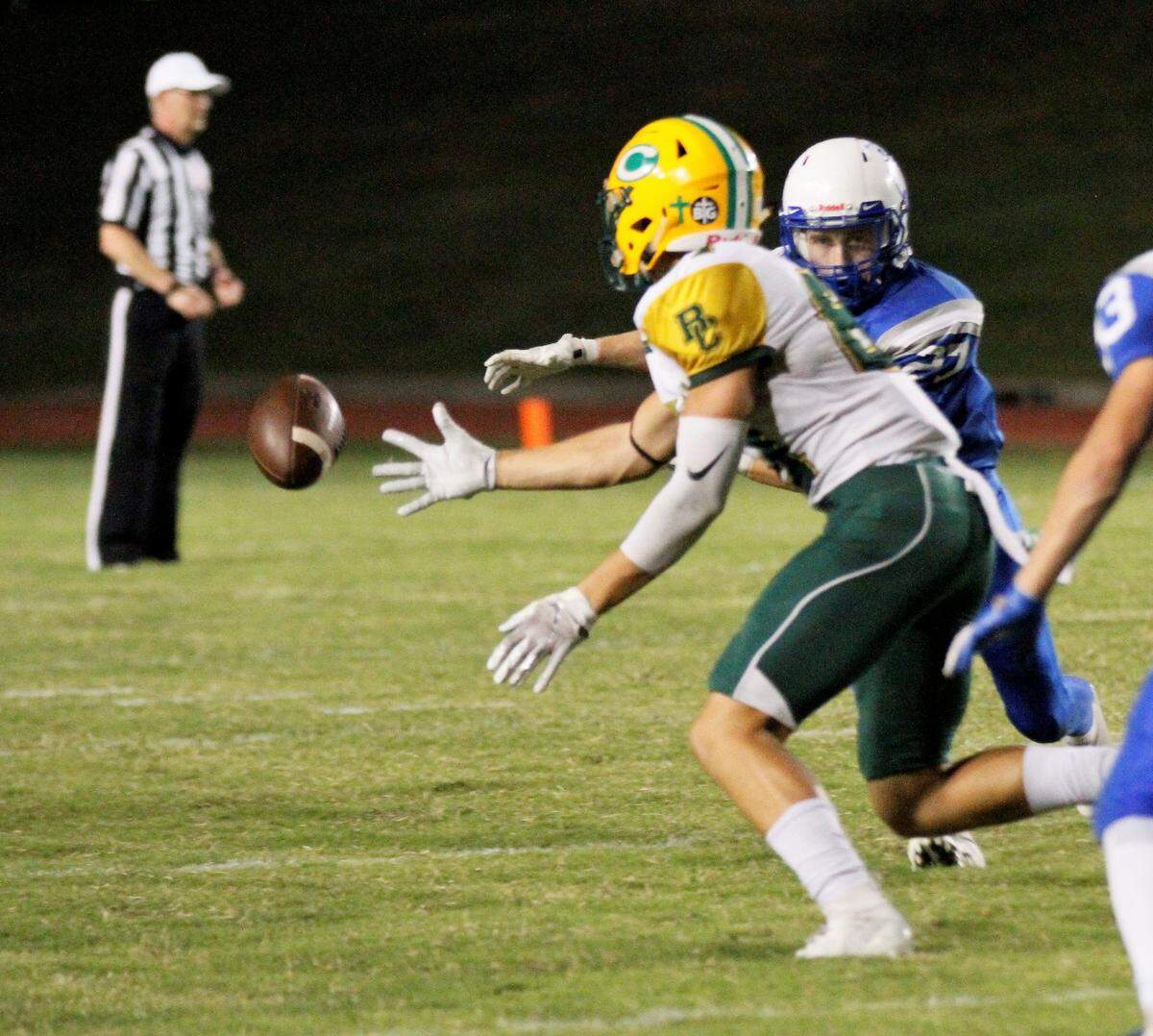 Bishop Carroll senior receiver Mason Baalman flips the ball to senior tight end Clay Cundiff for a pivotal hook and lateral play in the Golden Eagles’ 28-14 win at Kapaun on Friday.