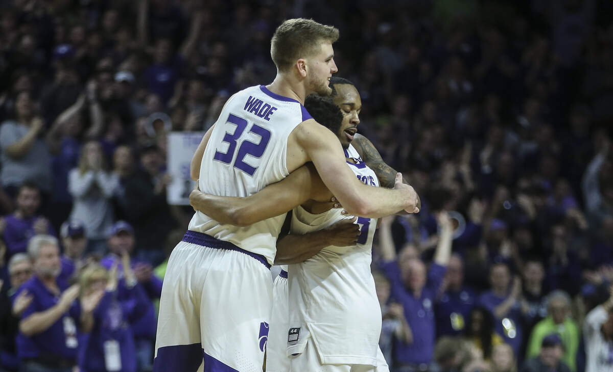 Kansas State seniors Dean Wade, Kamau Stokes and Barry Brown Jr., come together in embrace after they were taken out of Kansas State’s game against Oklahoma on Saturday. The trio led the Wildcats to the Big 12 title this season.