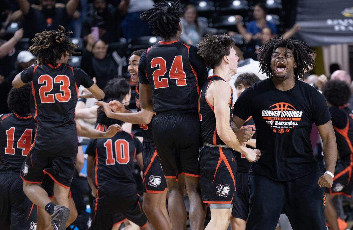 Members of the Bonner Springs High School boys basketball team celebrate the Braves’ victory over unbeaten Kapaun Mt. Carmel in the Kansas Class 5A state championship game at Koch Arena in Wichita.