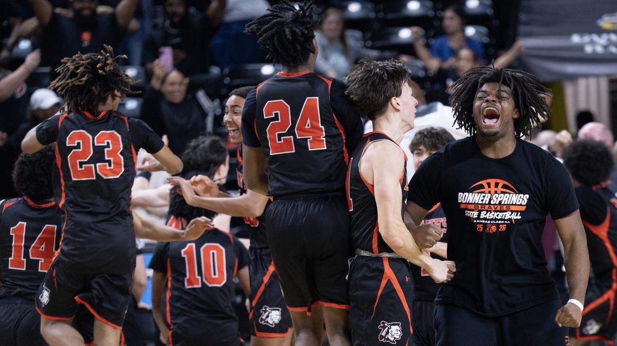 Members of the Bonner Springs High School boys basketball team celebrate the Braves’ victory over unbeaten Kapaun Mt. Carmel in the Kansas Class 5A state championship game at Koch Arena in Wichita.