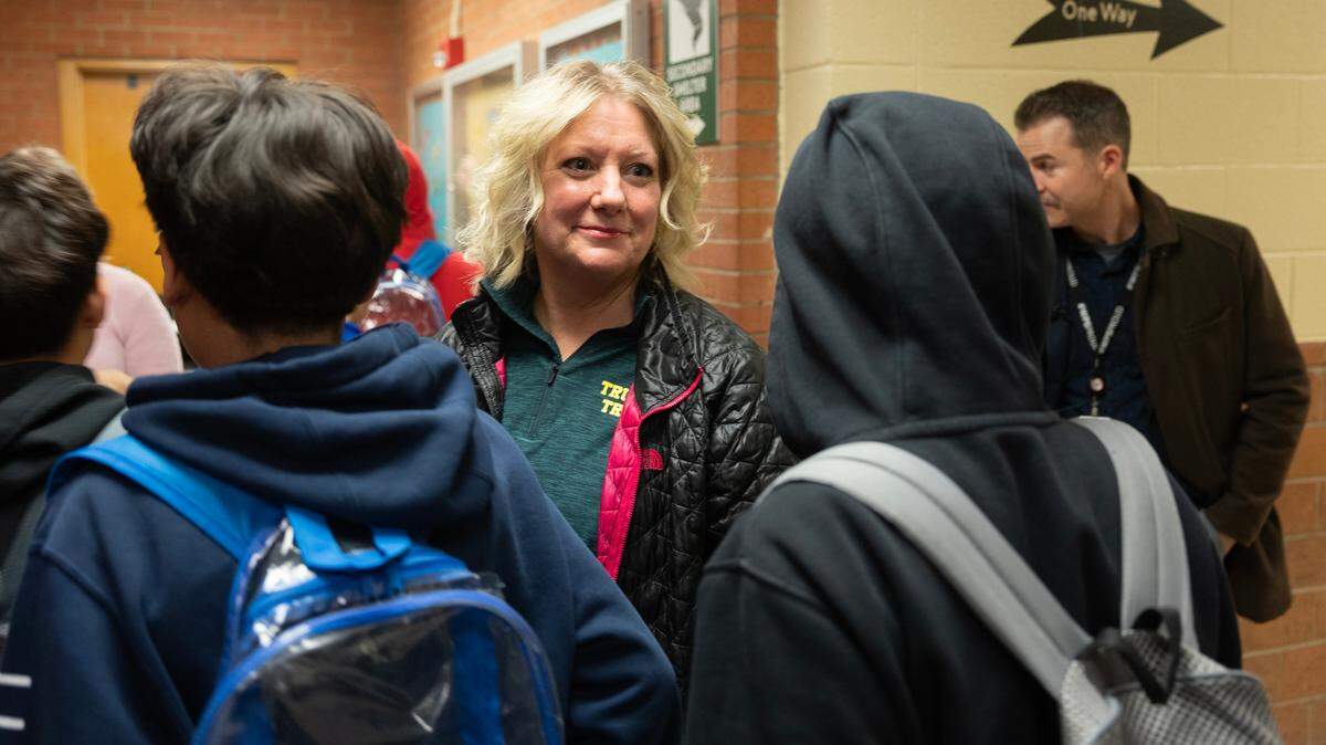 Truesdell Middle School Principal Amy Johnson walks through a crowded hallway during a passing period. The campus is so large that they have a 5-minute passing period.