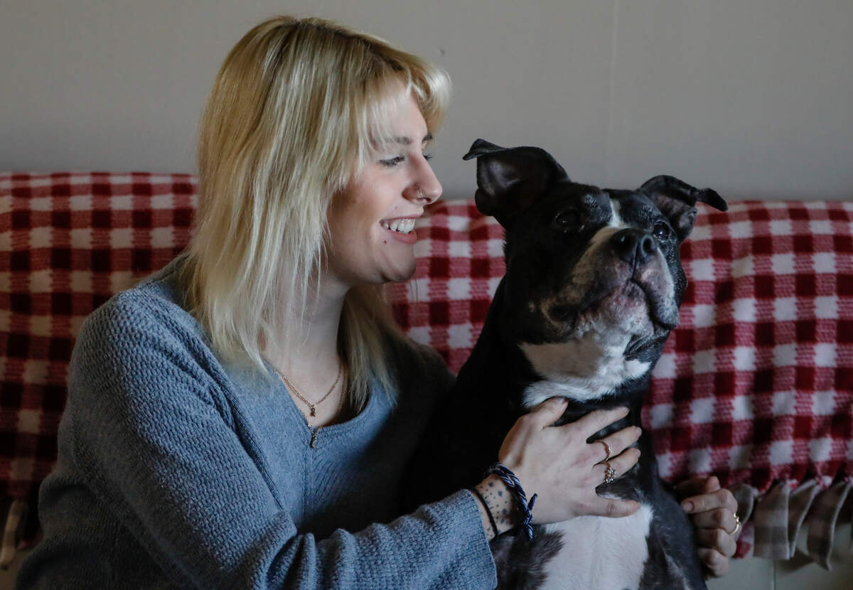 Brooklynn Nimmo embraces her dog, Wilbur. The family pitbull used to snuggle up to Nimmo’s mother before she was killed by Nimmo’s father. Wilbur now helps motivate Nimmo to get out of bed.