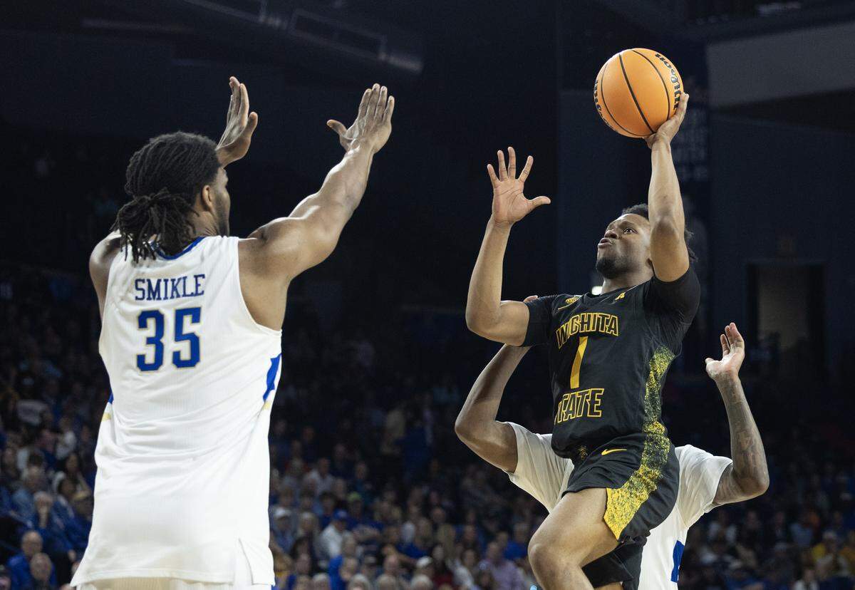 Wichita State’s Kenyon Giles hits a floater over Tulsa’s Ian Smikle during the second half on Tuesday.